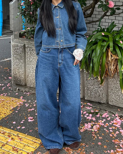 Wide-leg jeans with faded whisker wash.