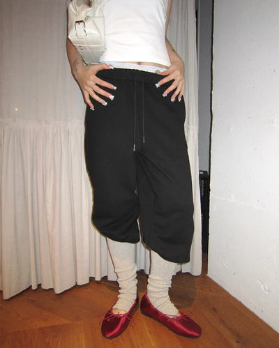 Open-heel ribbed knee-high socks layered pants