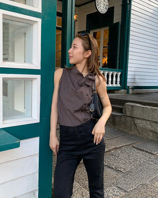 Checkered high-neck sleeveless blouse with bow tie