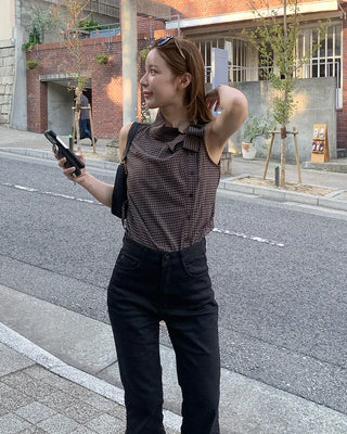 Checkered high-neck sleeveless blouse with bow tie
