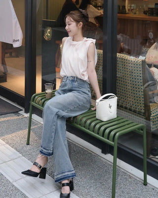 Sleeveless blouse with ribbon neckline