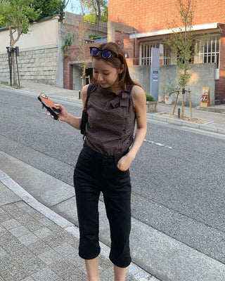 Checkered high-neck sleeveless blouse with bow tie