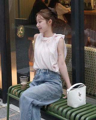 Sleeveless blouse with ribbon neckline