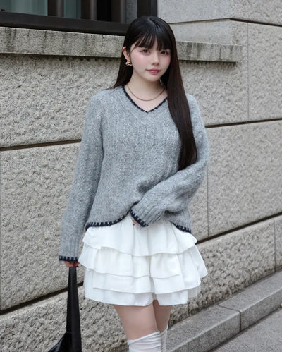 V-neck two-tone cable knit sweater