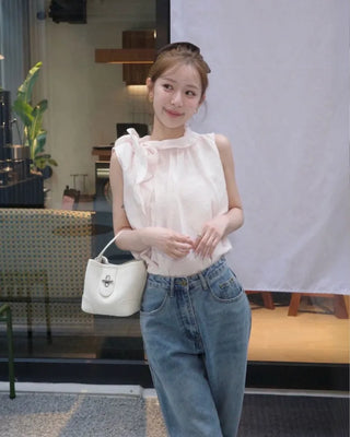 Sleeveless blouse with ribbon neckline
