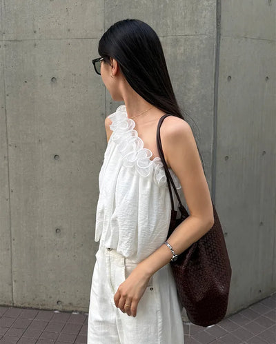 Asymmetrical ruffled sleeveless blouse