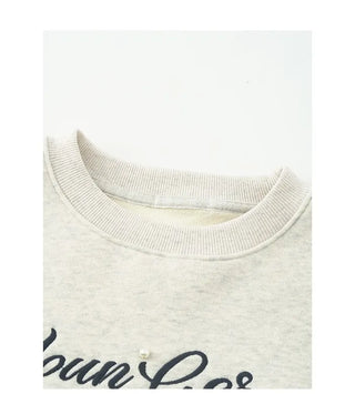 Fleece-lined sweatshirt with floral embroidery