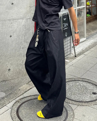 Double-pleated striped slacks