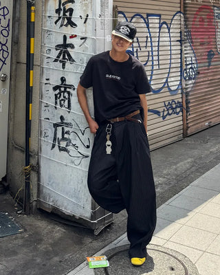 Double-pleated striped slacks