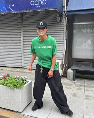 Double-pleated striped slacks