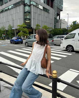 Perforated ruffle sleeveless top