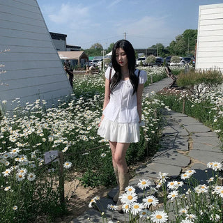 Short-sleeved summer outfit featuring a ruffled collar, puff sleeves, and shirred top.