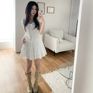 Short-sleeved top with ribbon collar, puff sleeves, and shirring.