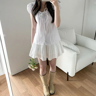 Short-sleeved summer outfit featuring a ruffled collar, puff sleeves, and shirred top.