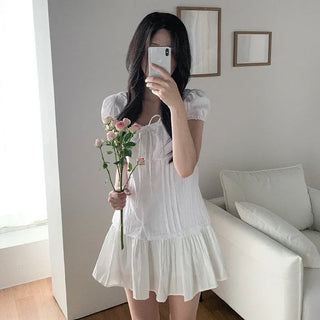 Short-sleeved summer outfit featuring a ruffled collar, puff sleeves, and shirred top.
