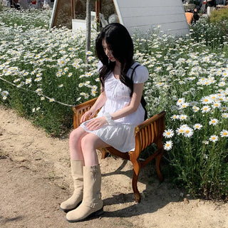 Short-sleeved summer outfit featuring a ruffled collar, puff sleeves, and shirred top.