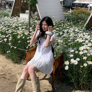 Short-sleeved summer outfit featuring a ruffled collar, puff sleeves, and shirred top.