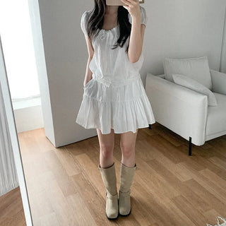 Short-sleeved top with ribbon collar, puff sleeves, and shirring.