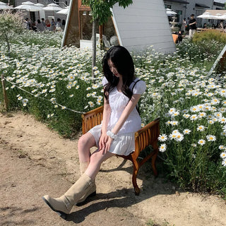 Short-sleeved summer outfit featuring a ruffled collar, puff sleeves, and shirred top.