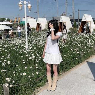 Short-sleeved summer outfit featuring a ruffled collar, puff sleeves, and shirred top.