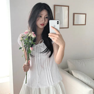 Short-sleeved summer outfit featuring a ruffled collar, puff sleeves, and shirred top.