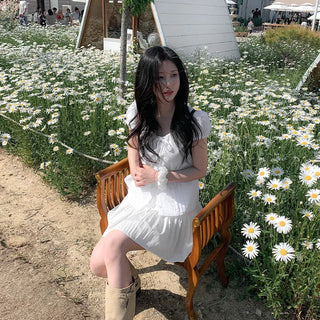 Short-sleeved summer outfit featuring a ruffled collar, puff sleeves, and shirred top.