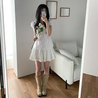 Short-sleeved summer outfit featuring a ruffled collar, puff sleeves, and shirred top.
