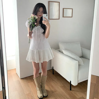 Short-sleeved summer outfit featuring a ruffled collar, puff sleeves, and shirred top.