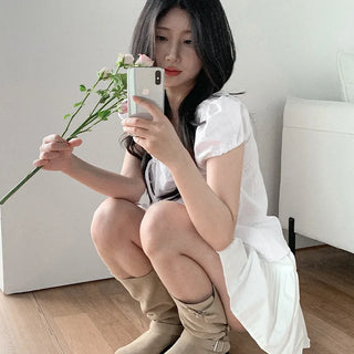 Short-sleeved summer outfit featuring a ruffled collar, puff sleeves, and shirred top.