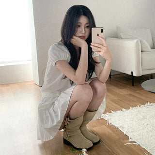 Short-sleeved top with ribbon collar, puff sleeves, and shirring.