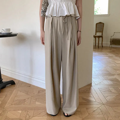 Banding pleated wide slacks with ribbon