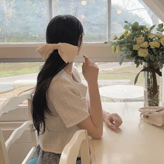 Cropped tweed collarless white jacket