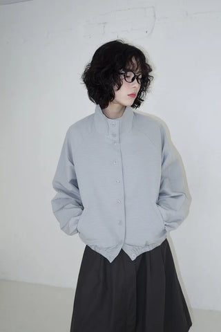 High-neck windbreaker with buttons