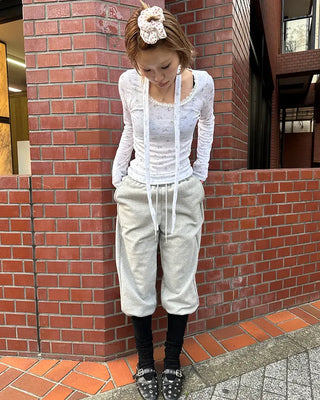 Open-heel ribbed knee-high socks layered pants