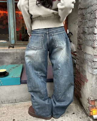 Seam-stitched distressed wide-leg denim pants