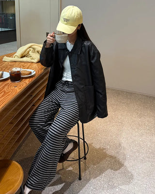 Two-tone leather jacket with contrasting sleeves.
