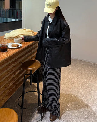 Two-tone leather jacket with contrasting sleeves.