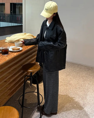 Two-tone leather jacket with contrasting sleeves.