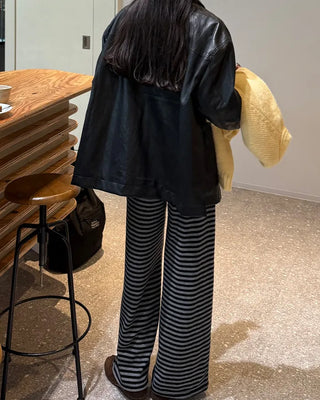 Two-tone leather jacket with contrasting sleeves.