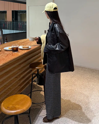 Two-tone leather jacket with contrasting sleeves.