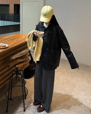Two-tone leather jacket with contrasting sleeves.