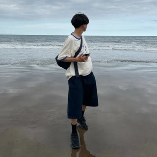 Wide-leg pleated half-length slacks