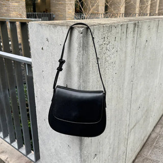 Round flap shoulder bag