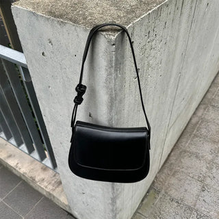 Round flap shoulder bag