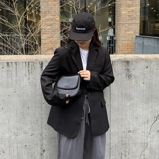 Round flap shoulder bag
