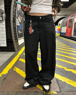 Coated black baggy denim pants