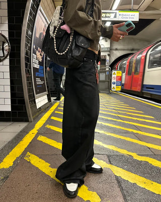 Coated black baggy denim pants