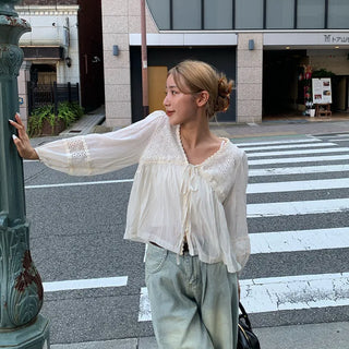 Punched open ribbon blouse