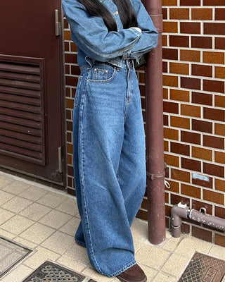 Wide-leg jeans with faded whisker wash.