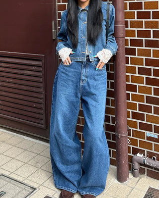 Wide-leg jeans with faded whisker wash.